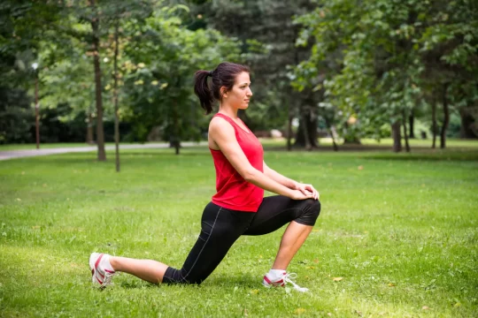 a woman stretching in a park
