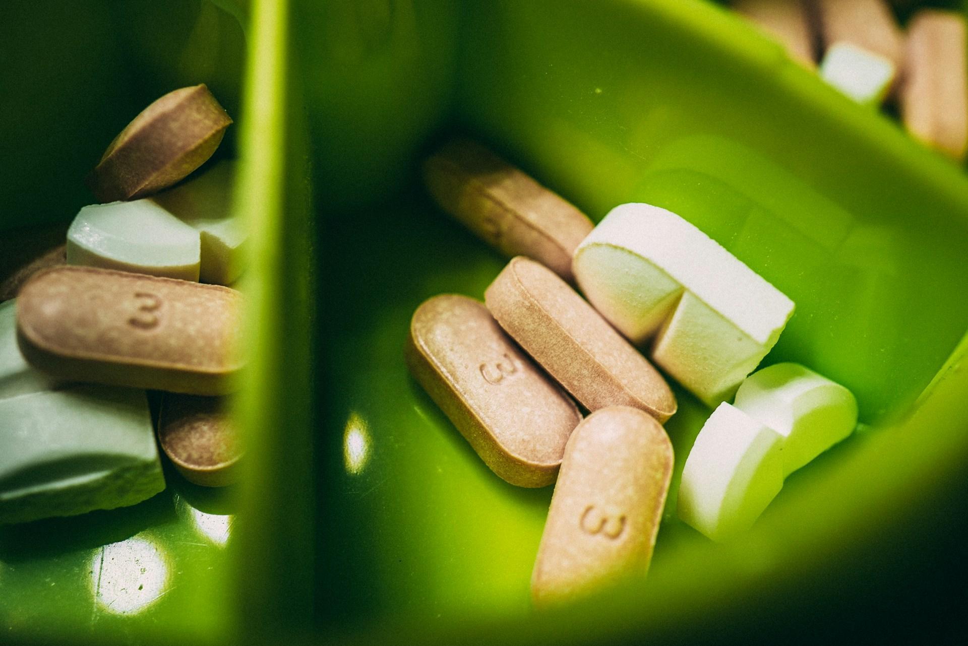 Medicine Tablets in a Green Bowl - Incorporating Supplements
